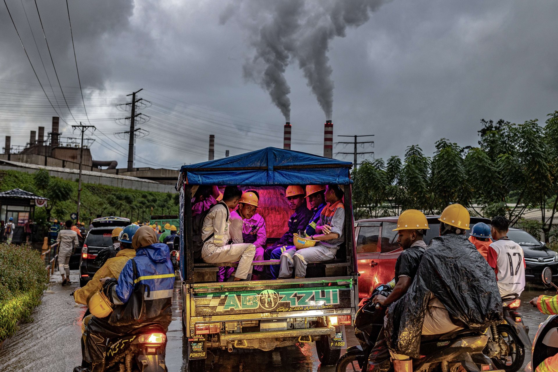 Workers ride towards a nickel smelting and processing plant, in Weda, Halmahera, Indonesia, amid heavy rains that continued for two days, causing flooding that impacted some 6,500 people.&nbsp;<br />
&nbsp;