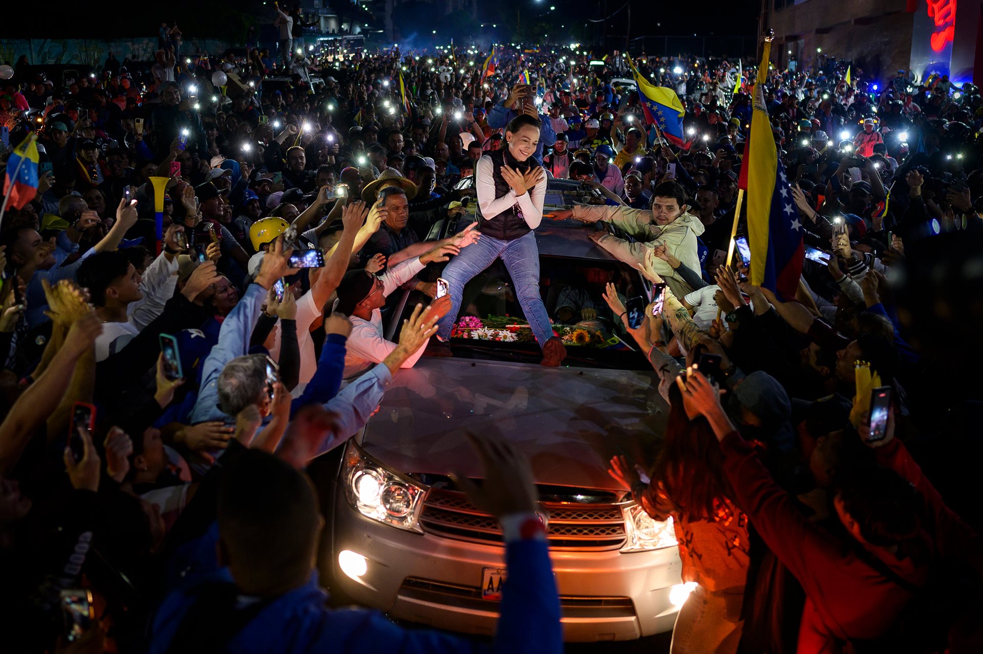 Venezuelan opposition leader María Corina Machado greets supporters atop a vehicle during a campaign rally for the opposition presidential candidate, Edmundo González Urrutia, in Mérida, Venezuela.