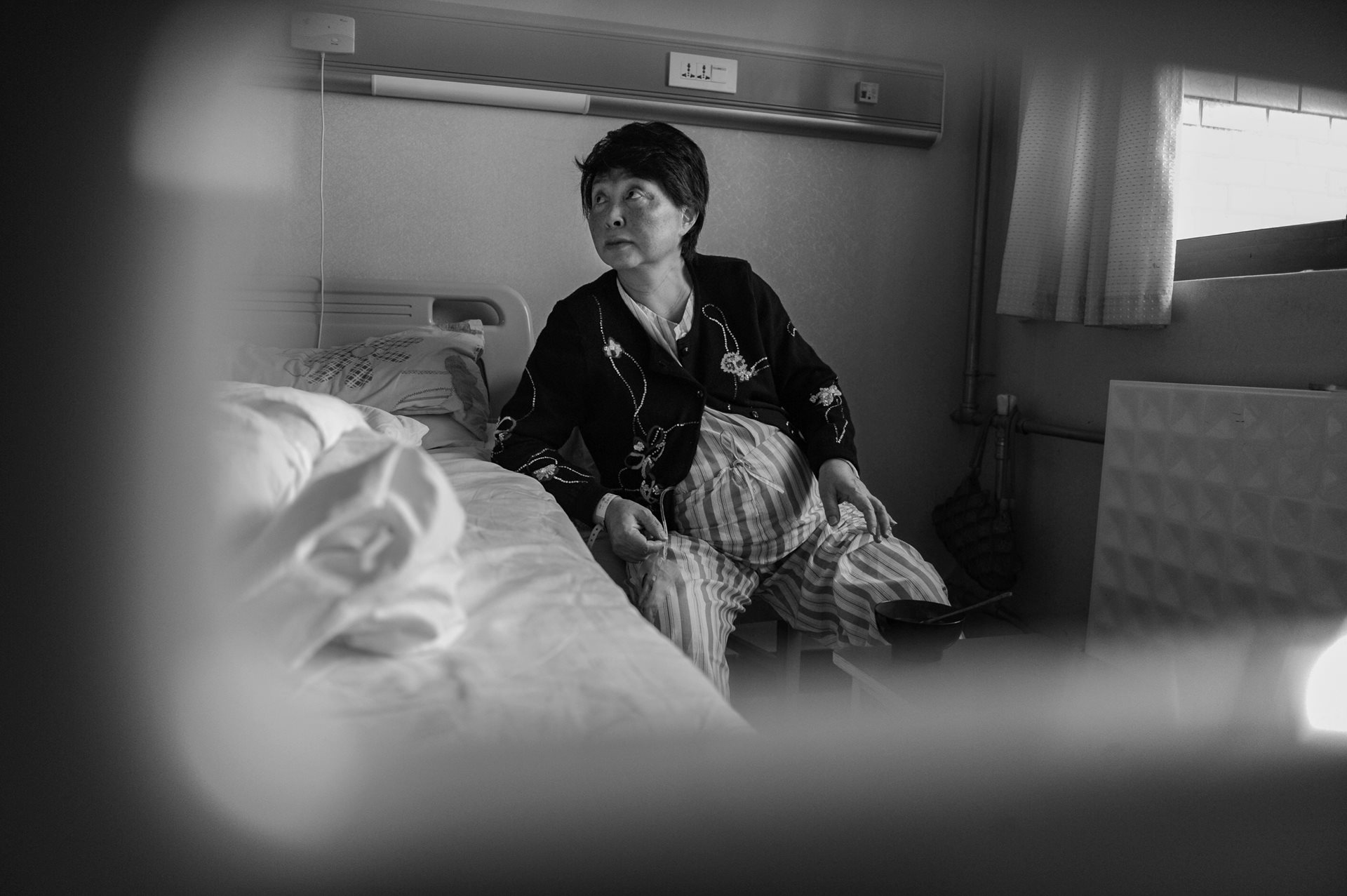 Sheng Hailin prepares for delivery at a hospital in Hefei, Anhui Province, China. At 60 years old and over seven months pregnant, she faced pain, hemorrhaging, and other physical hardships to bring her twin daughters into the world.
